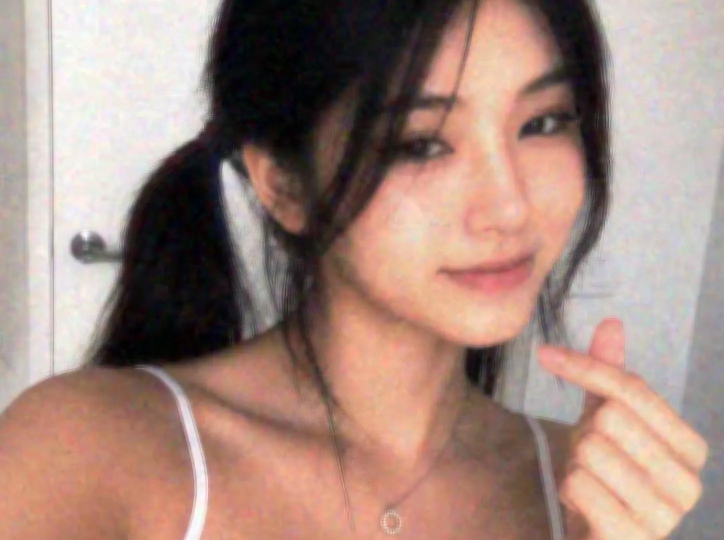 Grainy indoor selfie in the style of an early-2000s digital camera, shot in Rumi Cam