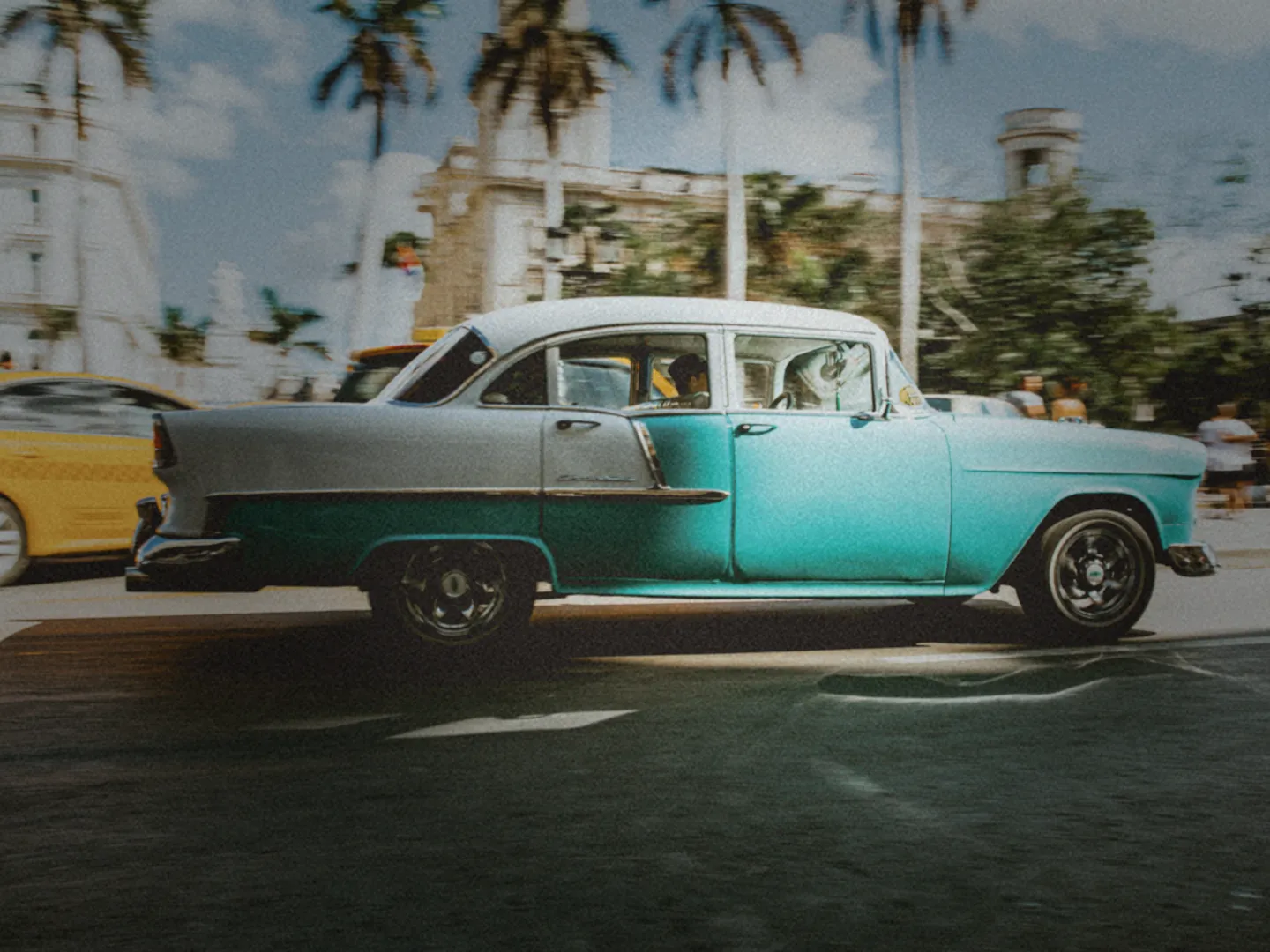 Classic turquoise car under palm trees, shot with a retro camera look in Rumi Cam on Android